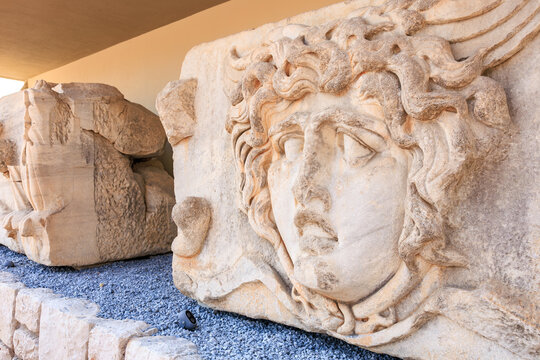 Ancient Medusa stone relief at archaeological site