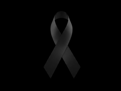 Symbol of mourning and remembrance, a black awareness ribbon isolated on a solid black background representing loss, grief, or support for a cause