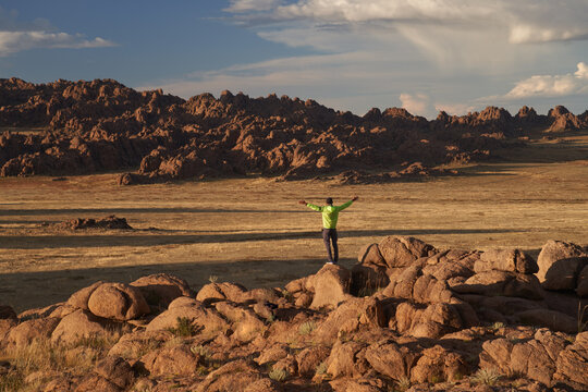 Silhouette of hiker man on rocky landscape, discovering natures beauty