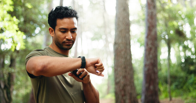 Fitness, athlete and man with smart watch, outdoor and workout progress on app, space and heart rate. Park, runner and person with technology for exercise update, break or health monitoring in nature - Powered by Adobe