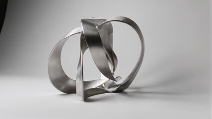 Abstract metallic sculpture on white background rotating smoothly in a seamless loop creating - Powered by Adobe