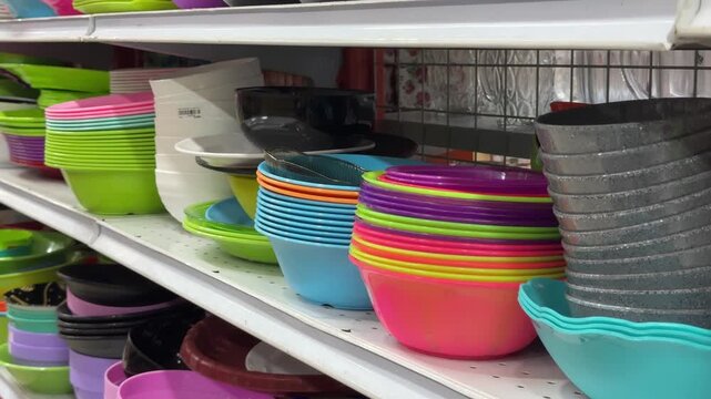 An attractive collection of plastic kitchen utensils is available on store shelves, offering versatile home storage solutions.