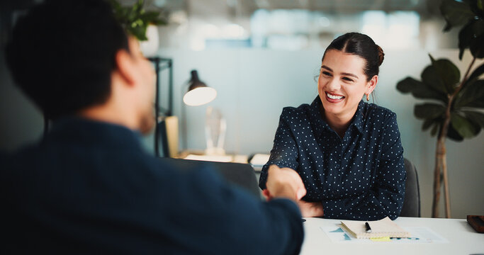 Interview, woman or people in office with handshake for recruitment, financial agreement or contract. Employer, job candidate or shaking hands in workplace with smile, onboarding or finance approval.