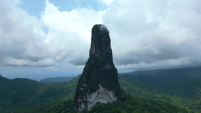 Flying in a circular pattern,close to peek Cao Grande, a gigantic monolith of volcanic origin. Shaped like a needle, it is 663 meters high located at the south of S&atilde;o Tom&eacute;,Africa.