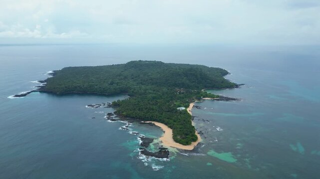 Aerial view from ilheu das Rolas,a islet in the archipelago of S&atilde;o Tom&eacute;, located in the Gulf of Guinea, south of the island.A volcanic origin, it lies directly on the Equator Line.Drone shot circular.