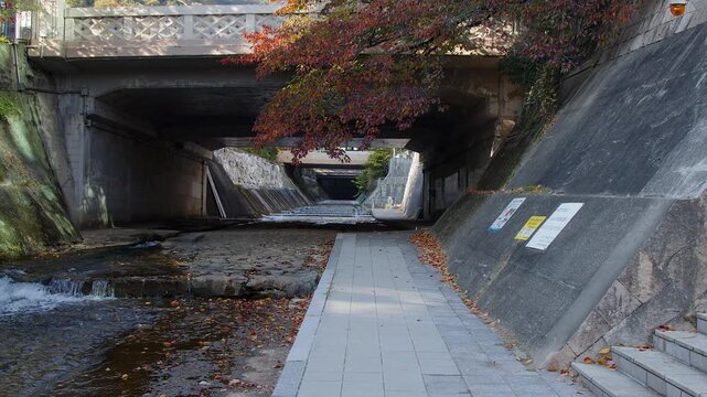 Ikutagawa River canal extending under autumn season streets in Kobe