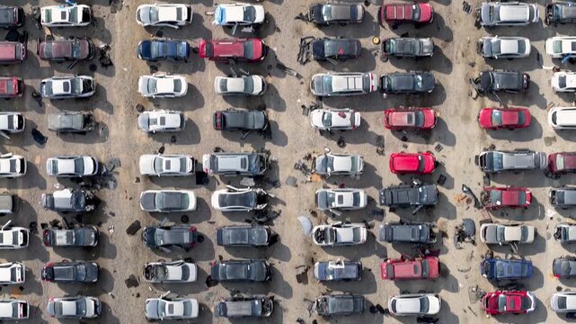 Aerial view of car scrap yard showing rows of abandoned accident vehicles for dis-assembly in Texas
