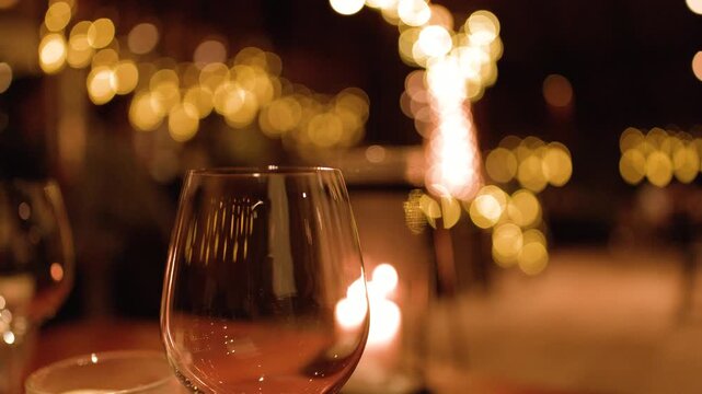 Empty Wine Glass on a Restaurant Table with Warm Bokeh Lighting