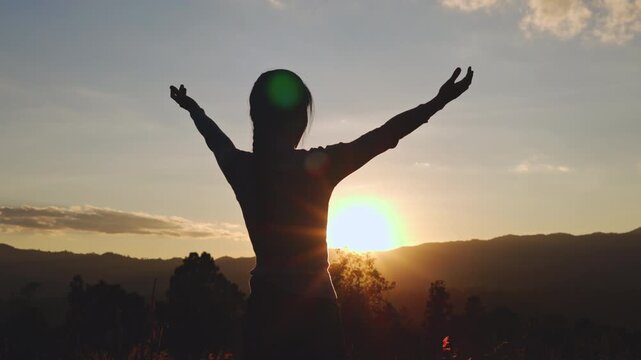 Video 4k Slow motion, Silhouette of woman Praying hands with faith in religion and belief in God On the morning sunrise background. Namaste or Namaskar hands gesture, Pay respect, Prayer position.