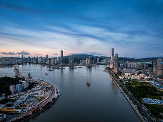 Naklejka premium Aerial view of the modern city skyline and river at dusk in Zhuhai and Macau.