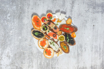 Assorted gourmet sandwiches with various toppings on a rustic plate