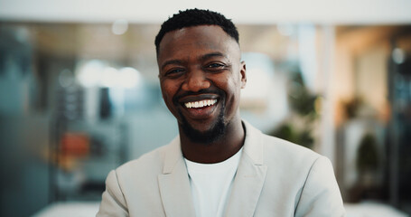 Naklejka premium Journalist, portrait or black man in agency with smile, experience or pride in media job. Happy, bokeh or male person in newsroom with confidence, about us or career growth in publishing industry.