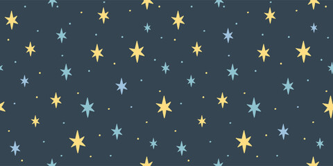 Naklejka premium Seamless pattern with scattered yellow and blue stars and dots on dark blue background creating starry night effect