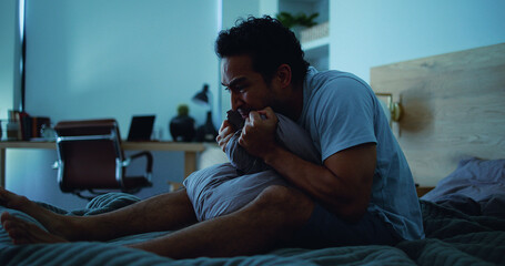 Fototapeta premium Night, pillow and stressed man with anxiety, mental health and sleepless from sad memories in bed. Late, contemplation and anxious person with depression, grief and insomnia from frustration in home.