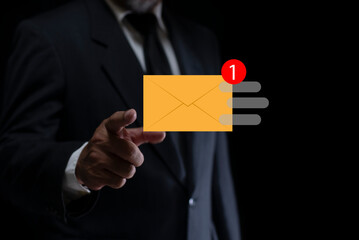 New email notification concept, Businessman checking new incoming email message by pointing finger on virtual screen to touch on the email icon.