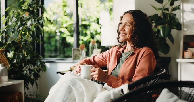 Home, thinking and woman with coffee, relax and reflection with memory, smile and comfort in lounge. Retirement, remember and mature person with tea, daydreaming and decision with moment and cosy