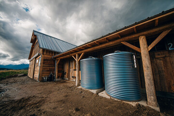 Water tanks beside barn support sustainable farming practices in rural setting Generative AI