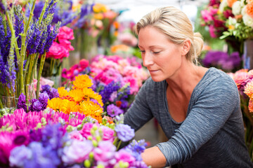 Flower arranging at a bustling farmers market in springtime Generative AI