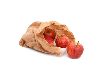 Red ripe apple fruits in paper bag isolated on white. Idea or concept to ecological consumption and zero waste.