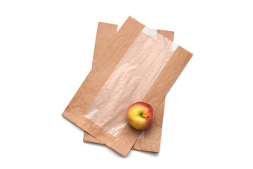Red ripe apple fruit on paper bag isolated on white. Idea or concept to ecological consumption and zero waste.