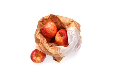 Red ripe apple fruits in paper bag above view isolated on white. Idea or concept to ecological consumption and zero waste.
