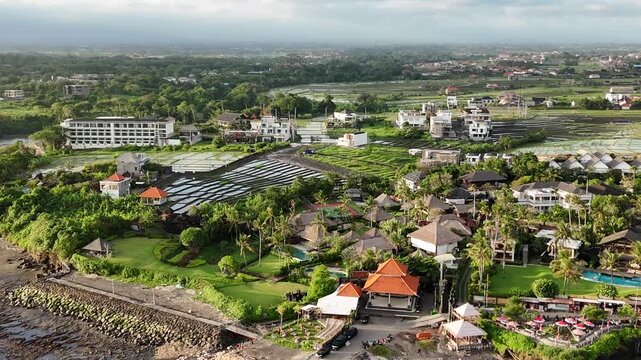 Bali cliff beach with a Hindu temple at Pantai Mengening beach/cliff side with Pura Gede Luhur Batu Ngaus temple located on the small peninsula off the cliffs from the main road. 