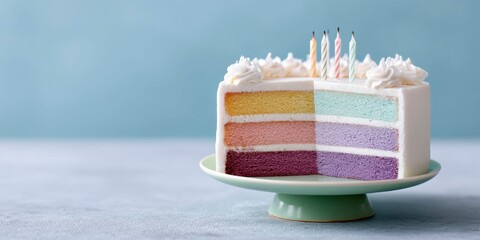 an open multi layer birthday cake with rainbow colored layers and candles on top, sitting alone on a small green pedestal against a blue background