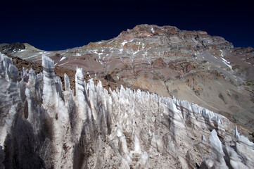 The enchanting beauty of the snowy mountains. The view of snow and rocks on the mountain tops.