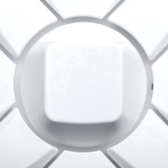 Abstract view of a white, square object centered in a circular frame with triangular shapes around the edges