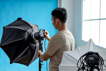 Photographer Adjusting Studio Lighting for Perfect Shot