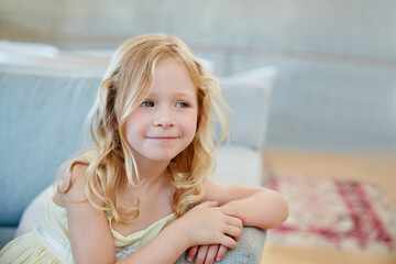 Happy, thinking and child on sofa in home for relaxing, resting and comfortable on weekend. House,...