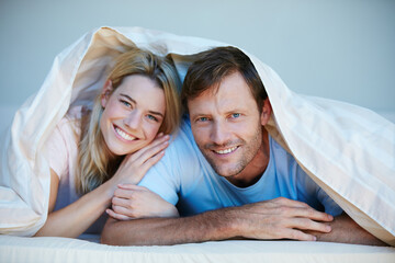 Portrait, blanket and love with couple in bedroom of home for bonding, support and wake up....