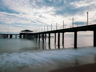 serene sunset scene with an old pier and calm sea
