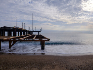 serene sunset scene with an old pier and calm sea