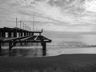 serene sunset scene with an old pier and calm sea