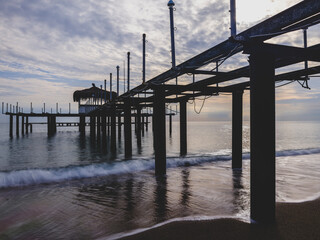 serene sunset scene with an old pier and calm sea