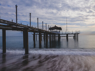 serene sunset scene with an old pier and calm sea