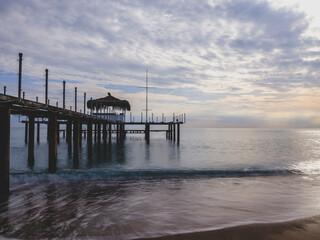 serene sunset scene with an old pier and calm sea