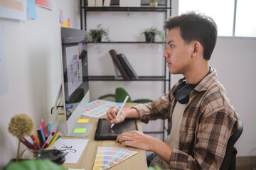 Young Graphic Designer Smiling While Working on Logo Design at Modern Desk