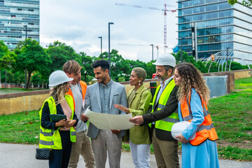 Diverse construction team collaborating on urban building project