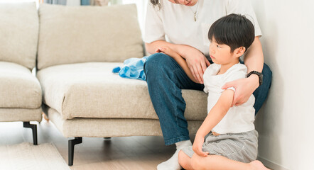 A father soothes a fussy boy in the living room of his home