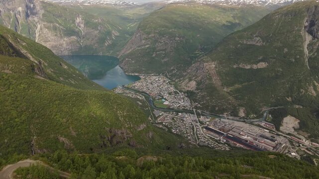 The Town of &Oslash;vre &Aring;rdal Sits Nestled Between Steep Green Mountains and a Deep Blue Fjord in Norway - Aerial Drone Shot