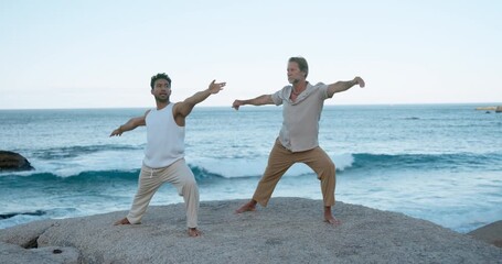 People, yoga and warrior pose at ocean with fitness for wellness, holistic health and coordination. Active, men outdoor and posture with exercise at beach for stretching, balance and inner peace.