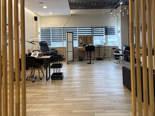 Premium coworking center for hair masters. Workplace of the hairdressers with illuminated mirrors and comfortable chairs. Concept of contemporary interior design for hairdresser. Beauty salon 