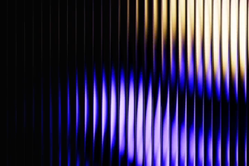 Wandcirkels Fractale golven Neon ribbed fractal glass 3d background. Holographic vertical stripe pattern with vibrant purple blue yellow gradient. Abstract black bg, iridescent texture lines in radiant colors  © marozhkastudio