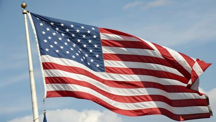 American flag waving in the wind on a sunny day