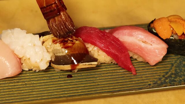 Chef Brushing Soy Sauce Over Assorted Omakase Sushi Nigiri