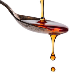 Golden syrup drips from vintage spoon on black background