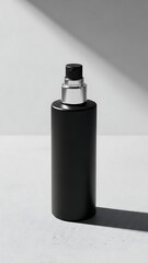 Elegant black perfume bottle against white backdrop with dramatic lighting