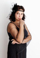 A woman wearing a black dress and a black hat